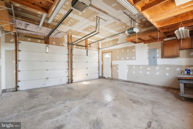 garage with a garage door opener and electric panel