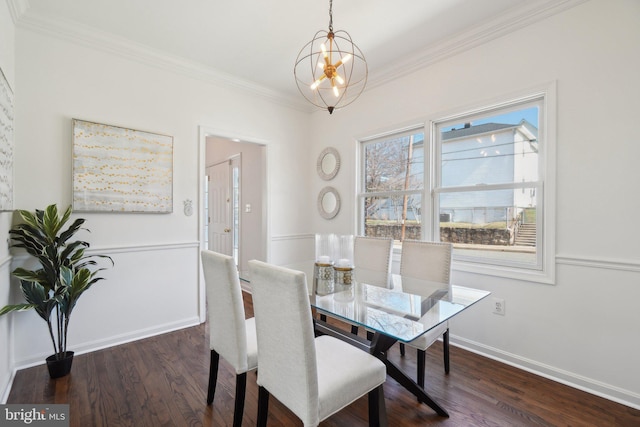 dining area with baseboards, ornamental molding, dark wood finished floors, and a notable chandelier