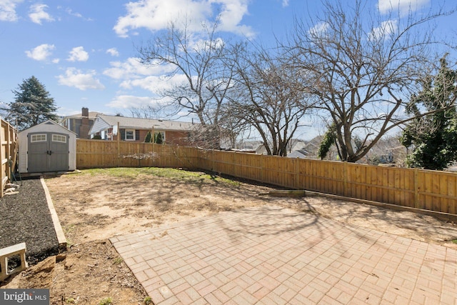 view of patio / terrace featuring an outbuilding, a fenced backyard, and a storage unit