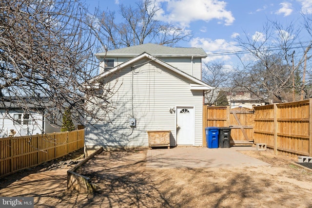 back of house with a gate and a fenced backyard