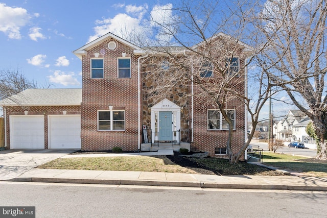 view of front facade featuring a garage, concrete driveway, brick siding, and stone siding