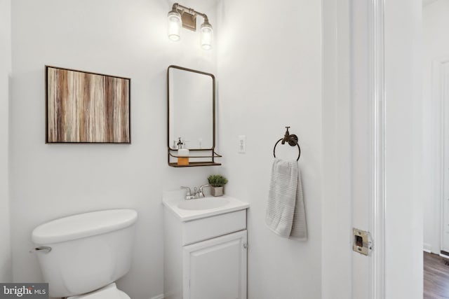 bathroom with toilet and vanity