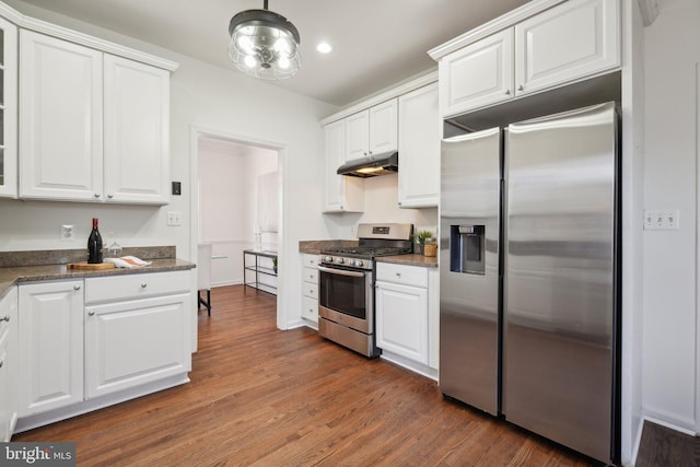 kitchen with appliances with stainless steel finishes, white cabinets, and under cabinet range hood