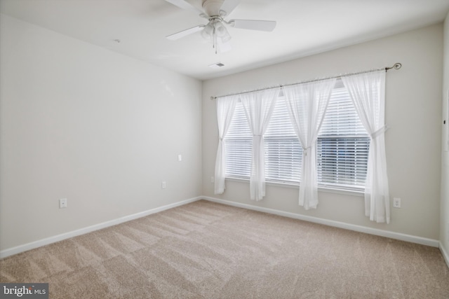 carpeted empty room featuring ceiling fan