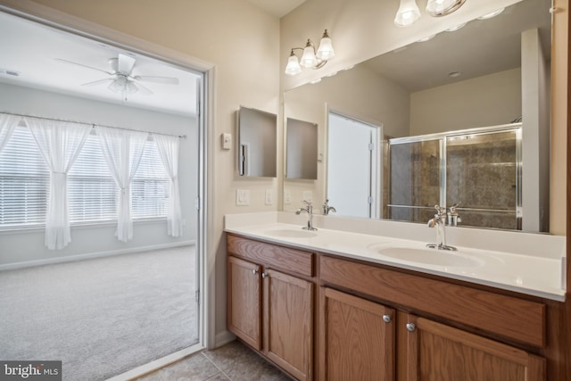 bathroom with walk in shower, vanity, ceiling fan, and tile patterned flooring