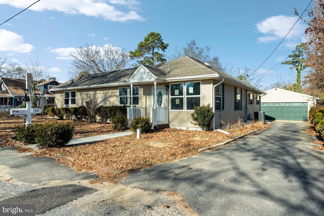 ranch-style home with an outbuilding, a garage, and cooling unit