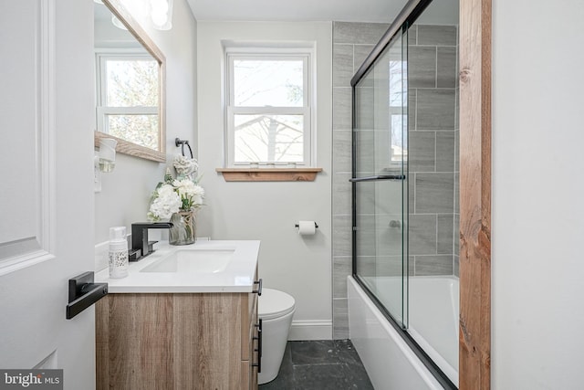 full bathroom with vanity, toilet, and combined bath / shower with glass door