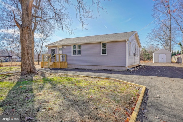 back of property with a shed