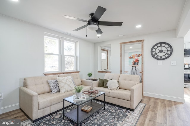 living room with ceiling fan and light hardwood / wood-style floors