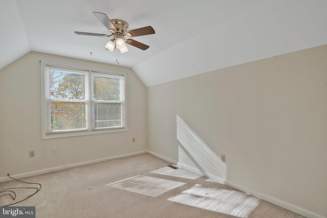 additional living space with light colored carpet, ceiling fan, and lofted ceiling