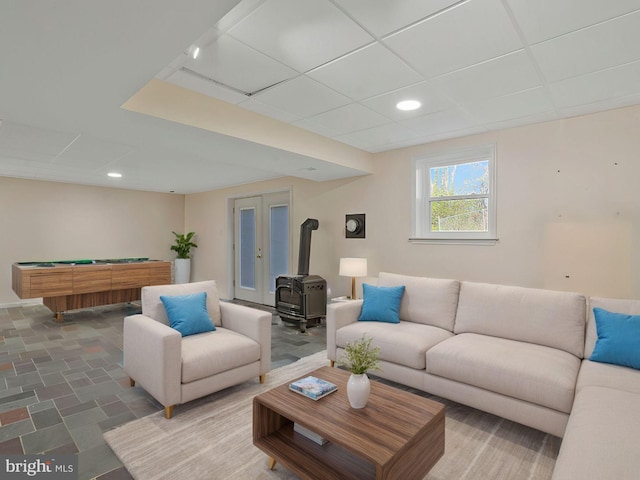 living room with a wood stove and pool table