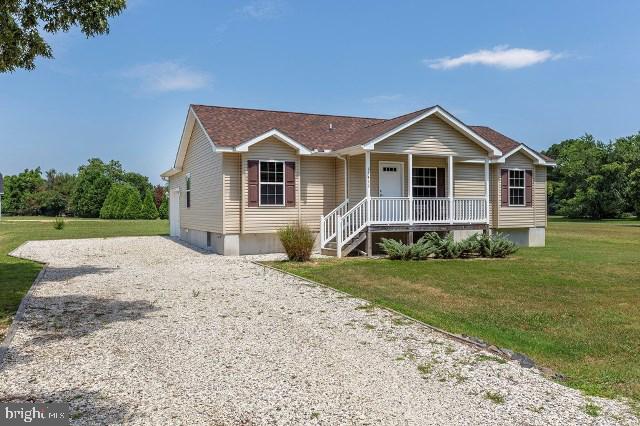 view of front of property with covered porch and a front yard