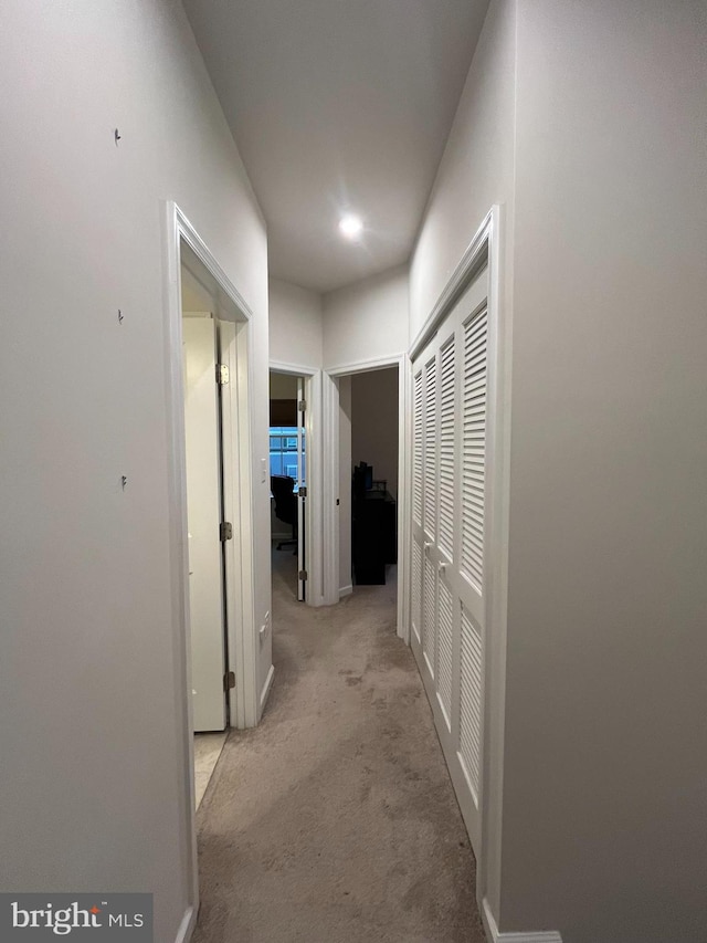 hallway with light colored carpet