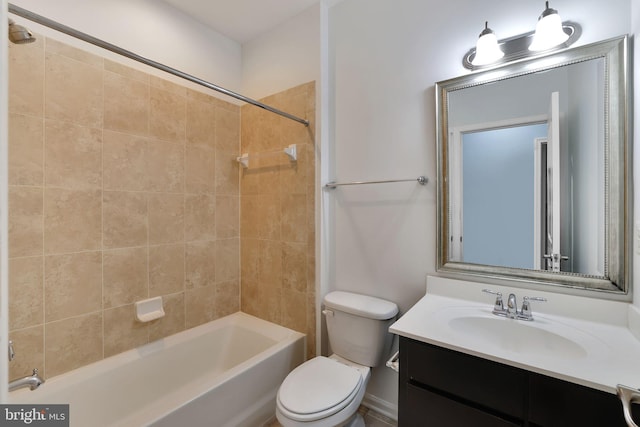 full bathroom featuring vanity, toilet, and tiled shower / bath