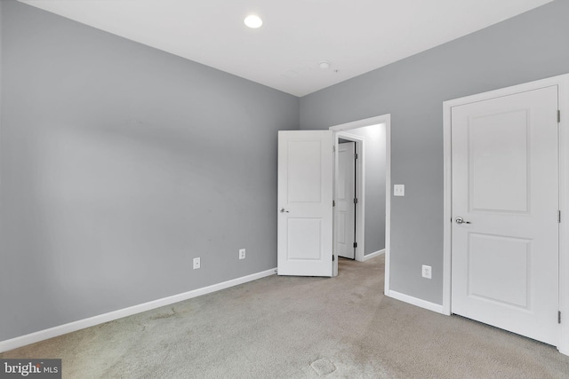 unfurnished bedroom with light colored carpet