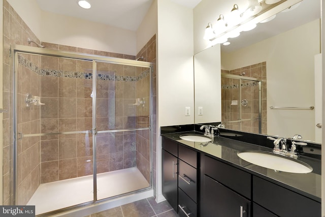 bathroom with tile patterned flooring, vanity, and a shower with door