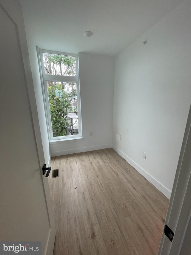 spare room featuring light wood-type flooring