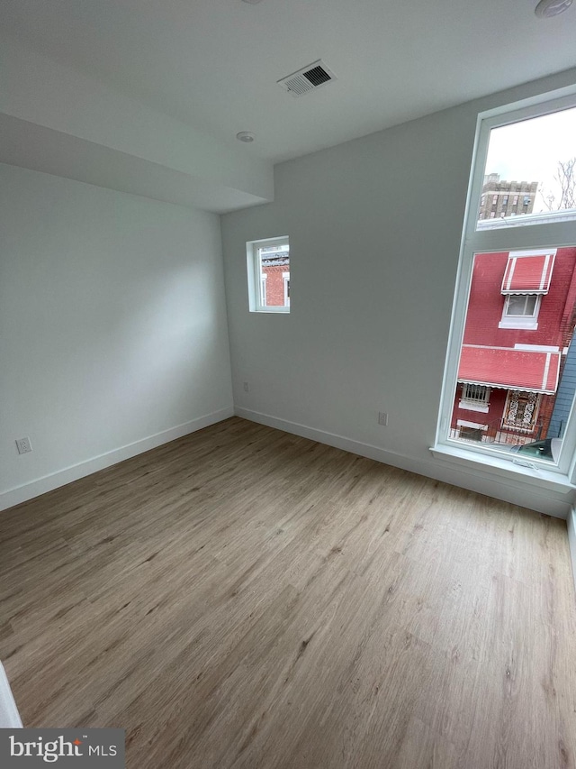 empty room featuring hardwood / wood-style flooring and a wealth of natural light