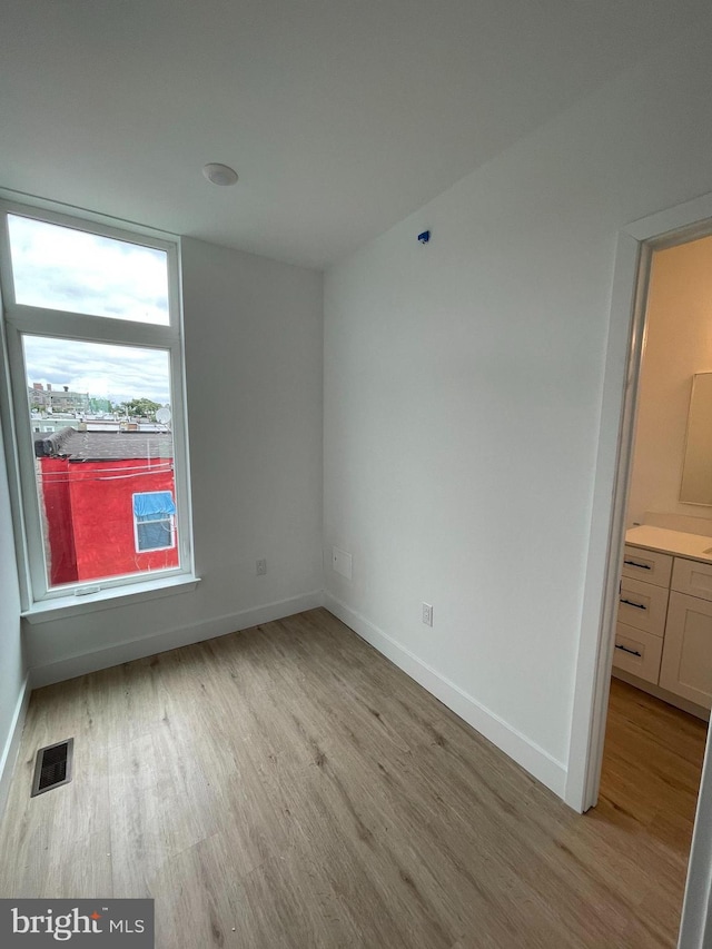 spare room with light hardwood / wood-style floors