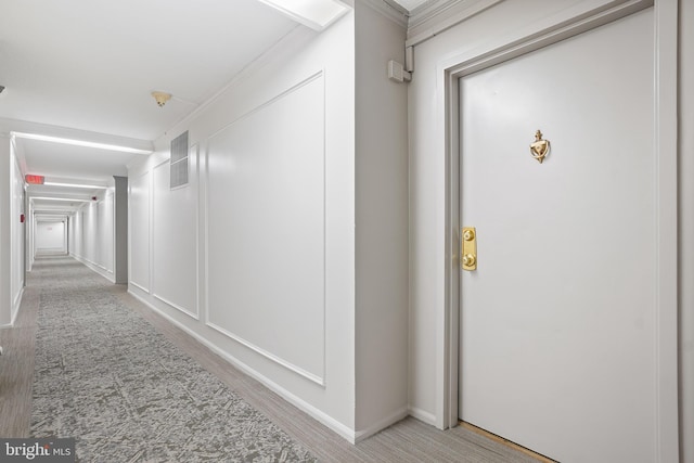 corridor featuring carpet and crown molding