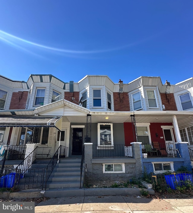 townhome / multi-family property featuring a porch