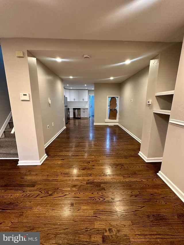 unfurnished living room featuring dark wood-type flooring