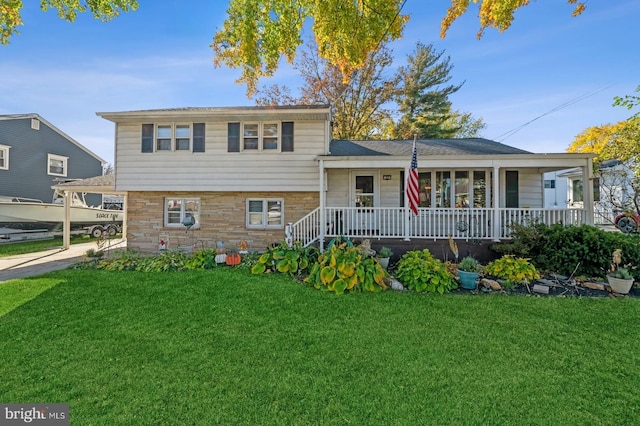 tri-level home with a porch and a front lawn