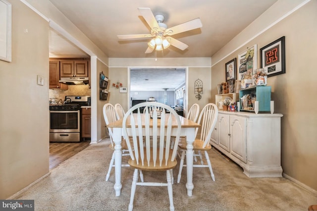 dining space with ceiling fan and light wood-type flooring