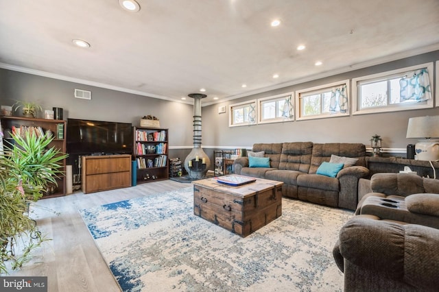 living room featuring light wood-type flooring and crown molding