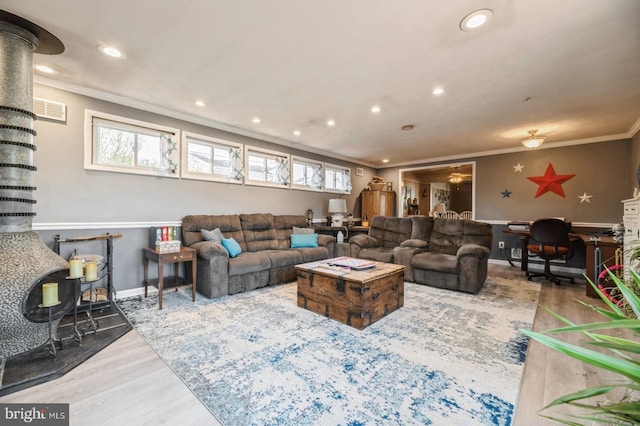 living room with crown molding, a healthy amount of sunlight, and hardwood / wood-style flooring