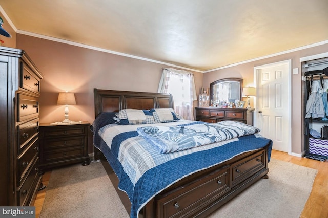 bedroom with crown molding and light hardwood / wood-style flooring