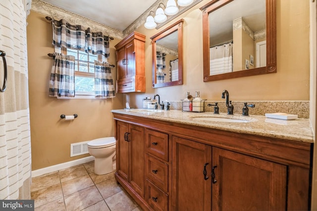 bathroom featuring tile patterned floors, vanity, and toilet