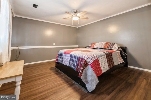 bedroom featuring ceiling fan, dark hardwood / wood-style flooring, and crown molding