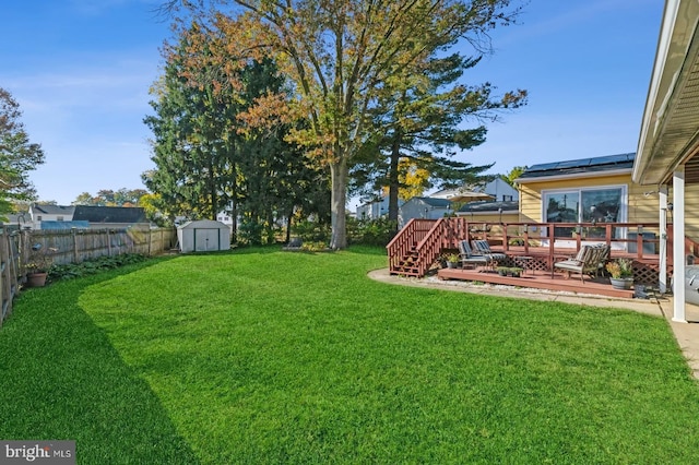 view of yard with a storage unit and a deck