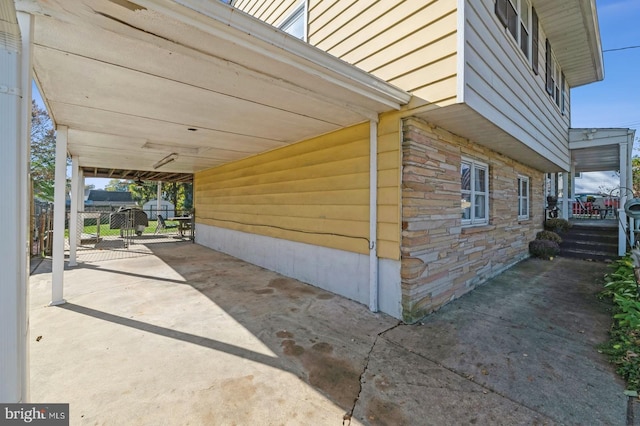 view of property exterior with a carport