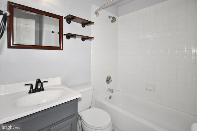 full bathroom featuring vanity, toilet, and tiled shower / bath