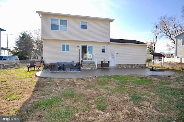 back of property featuring a yard, a patio, and an outdoor hangout area