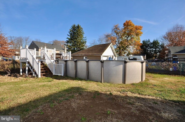 view of yard with a swimming pool side deck