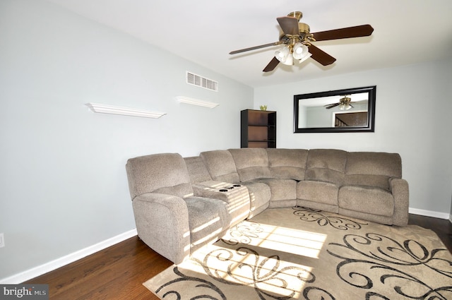 living room with dark hardwood / wood-style flooring and ceiling fan