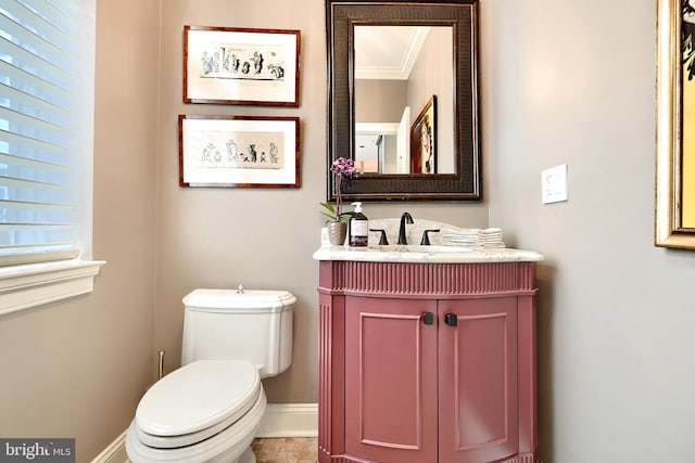 bathroom featuring vanity, ornamental molding, and toilet