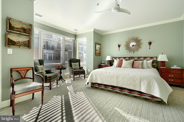 carpeted bedroom with ornamental molding and ceiling fan