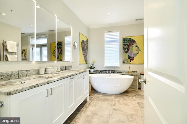 bathroom featuring crown molding, vanity, and a washtub