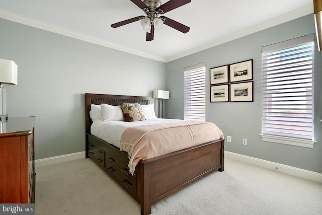 bedroom with crown molding, light colored carpet, and ceiling fan