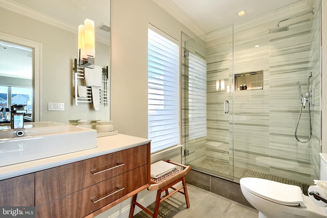 bathroom featuring crown molding, vanity, a shower with shower door, tile patterned floors, and toilet