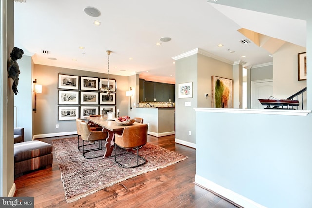 dining space featuring dark wood-type flooring and ornamental molding