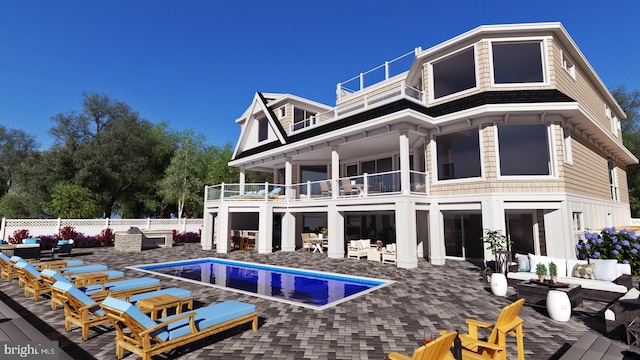 rear view of house featuring outdoor lounge area, a balcony, and a fenced in pool