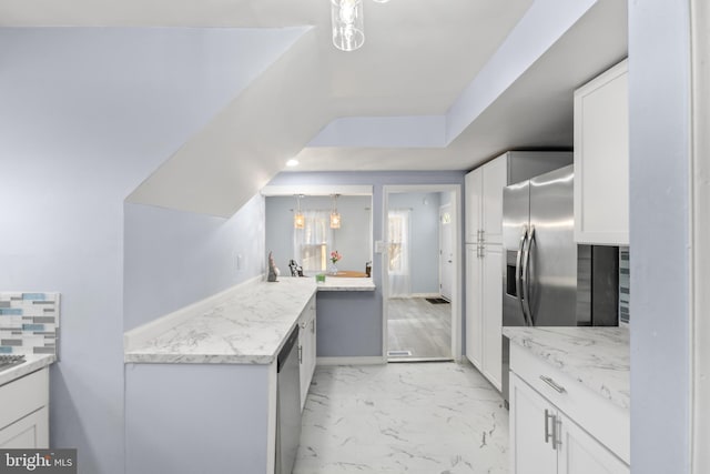 kitchen with marble finish floor, light stone counters, backsplash, and white cabinets