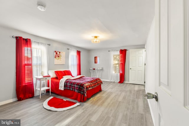 bedroom with baseboards and wood finished floors