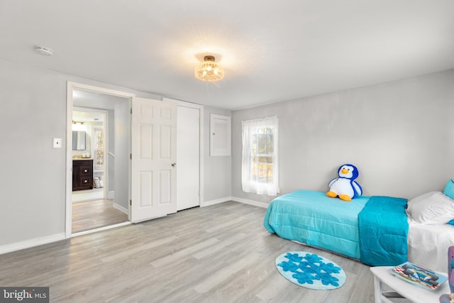 bedroom featuring baseboards and wood finished floors