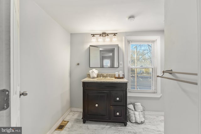 bathroom featuring marble finish floor, baseboards, visible vents, and vanity